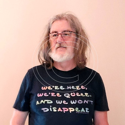 Brian models a t-shirt with his 'We're Here, We're Queer, We Won't Disappear' logotype.